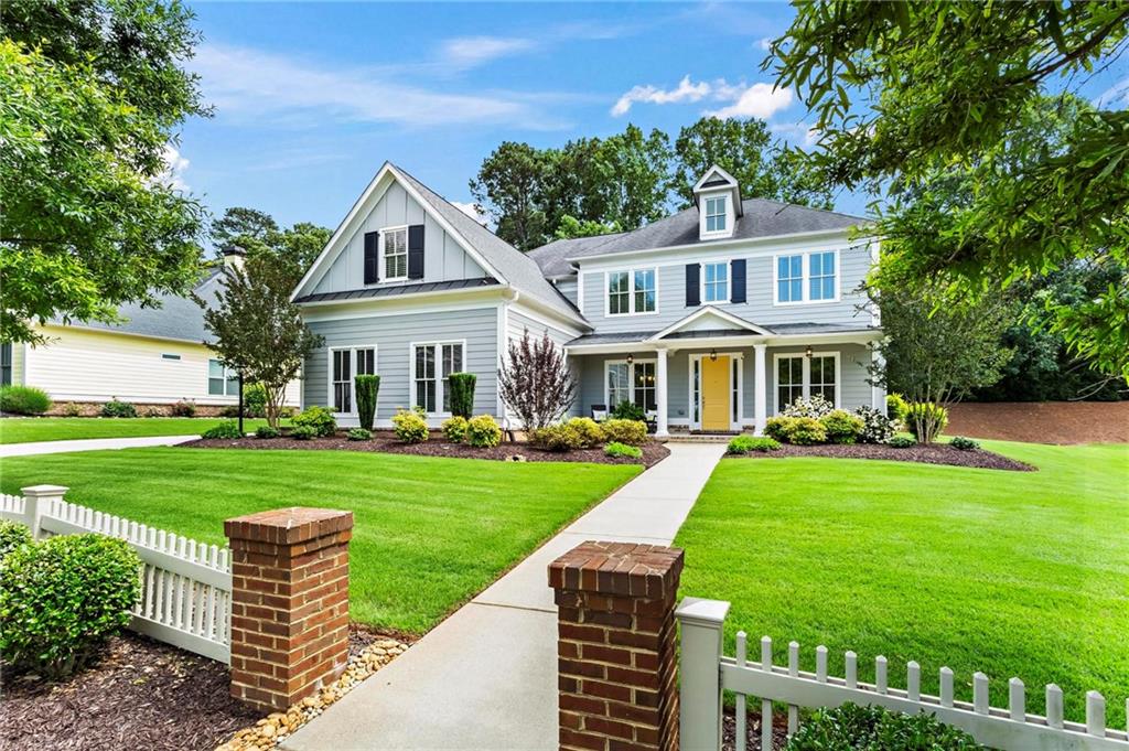a front view of a house with garden and porch