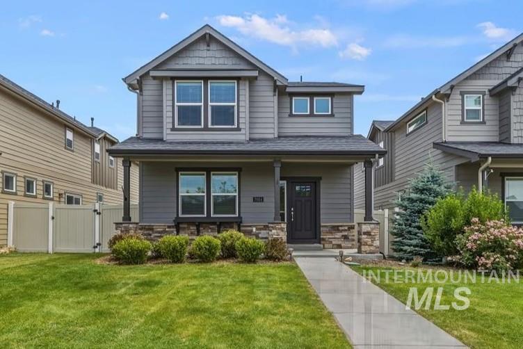 7984 South Indigo Ridge Avenue Boise, ID 83716 - Photo 1 of 1 Contemporary two-story residence featuring a gray horizontal siding and stone veneer facade