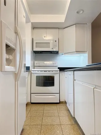 a kitchen with a stove and cabinets