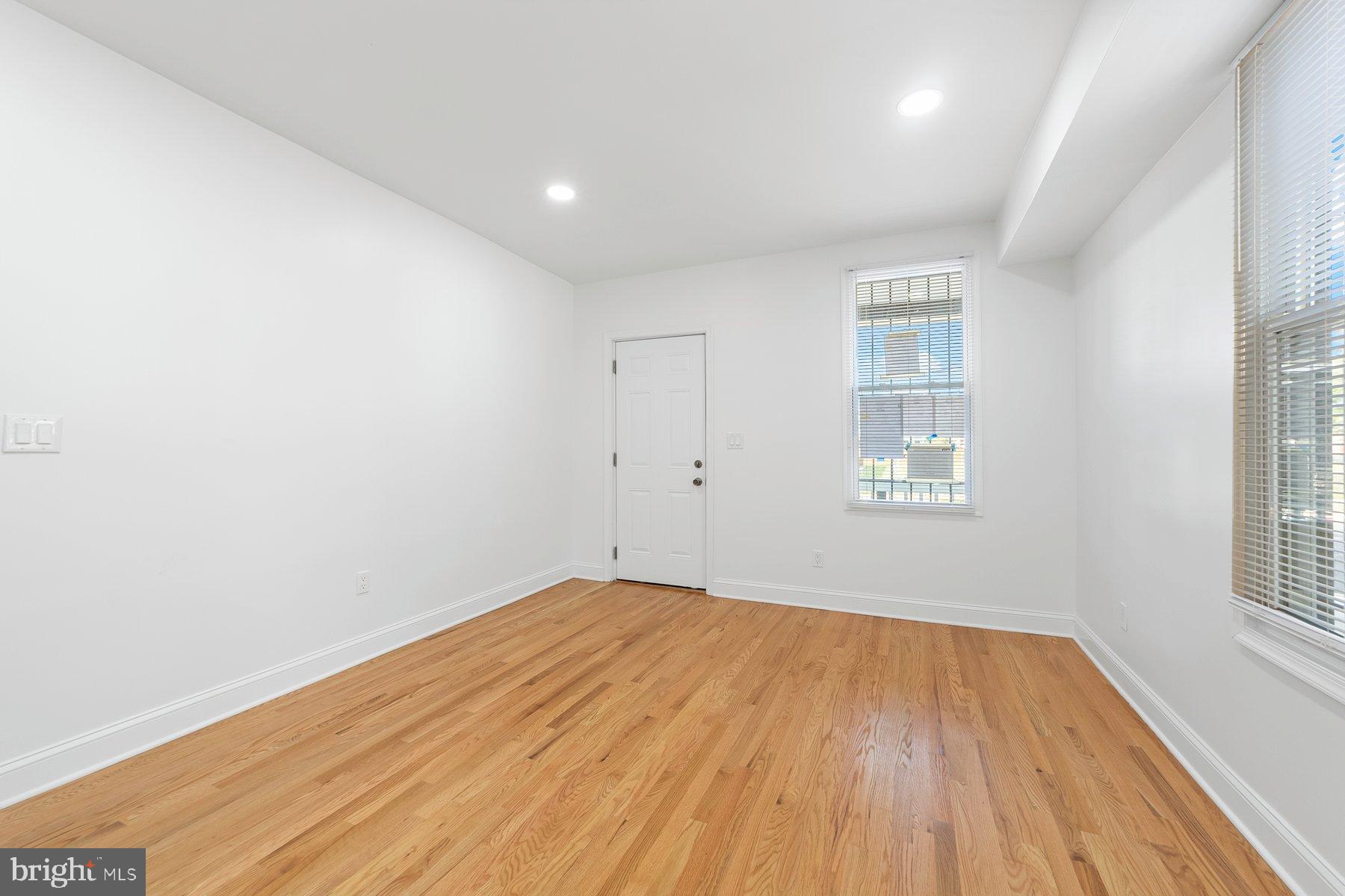 1325 W Street Southeast Washington, DC 20020 - Photo 16 of 26 an empty room with wooden floor and windows