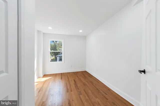 a view of a room with wooden floor and window