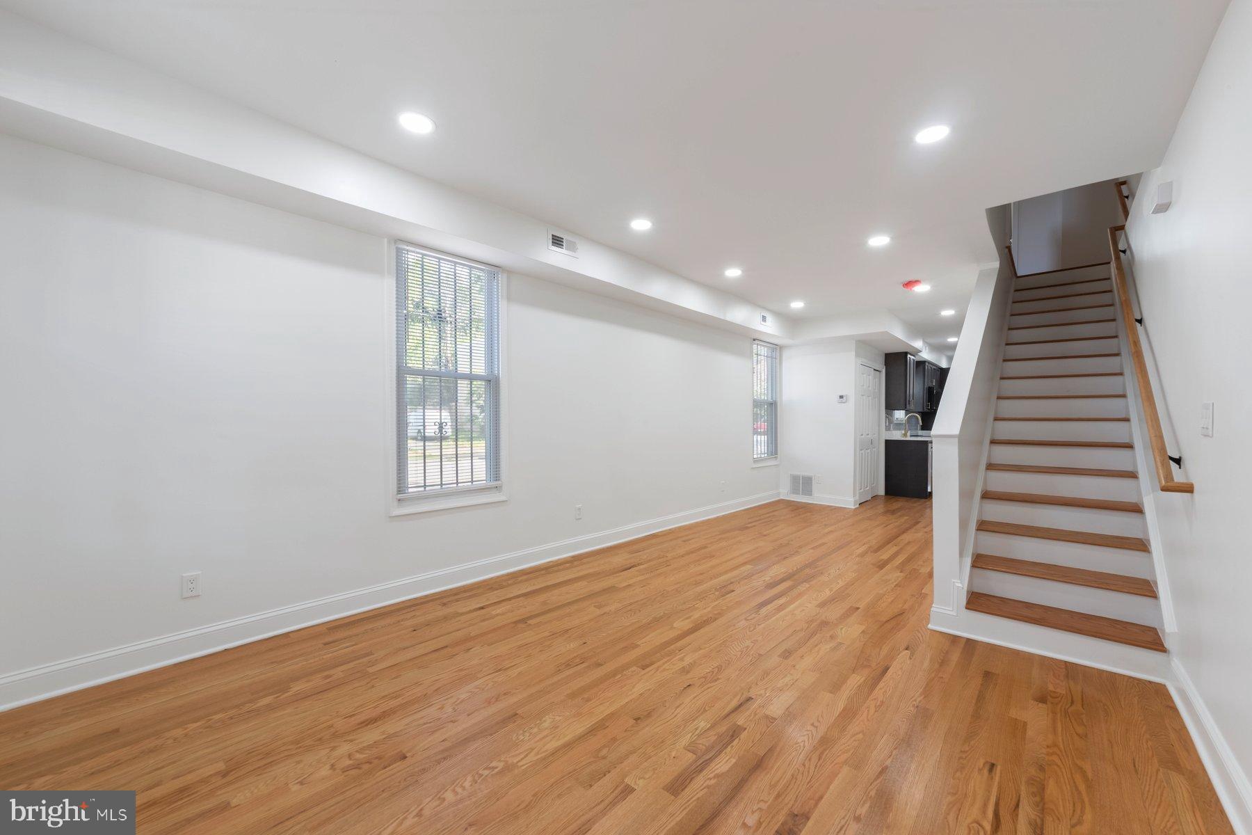 1325 W Street Southeast Washington, DC 20020 - Photo 8 of 26 a view of an empty room with wooden floor and stairs