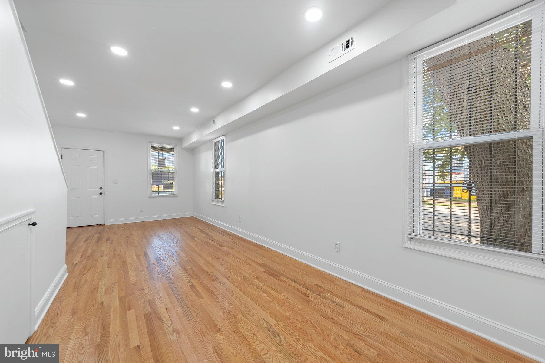 1325 W Street Southeast Washington, DC 20020 - Photo 10 of 26 wooden floor in an empty room with a window
