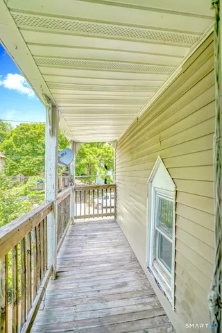 a view of a balcony with wooden floor