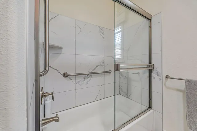 a bathroom with a glass shower door