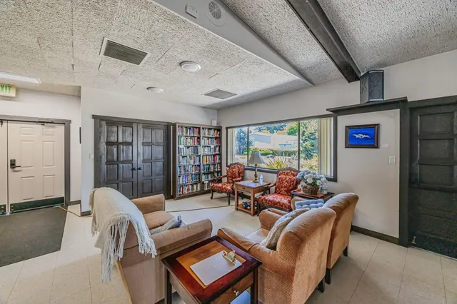 a living room with furniture a ceiling fan and a rug