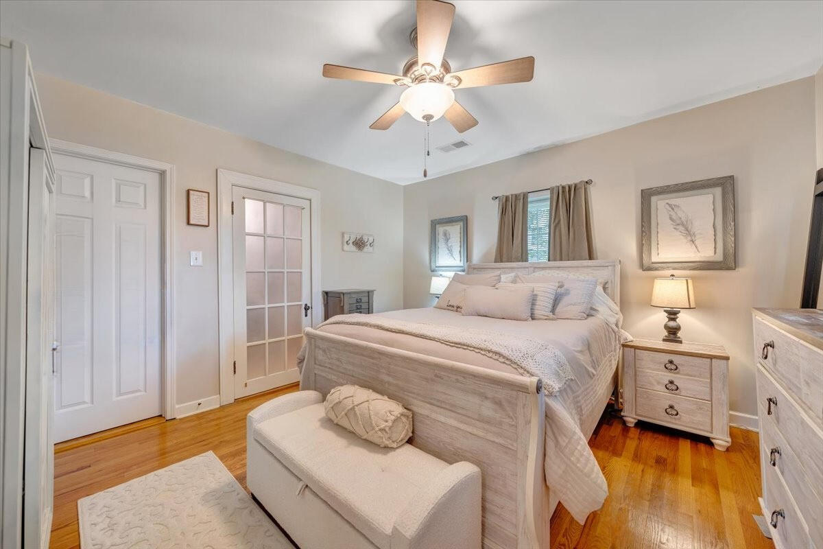 898 Mica Road Ridgeway, VA 24148 - Photo 15 of 60 a spacious bedroom with a bed and a chandelier