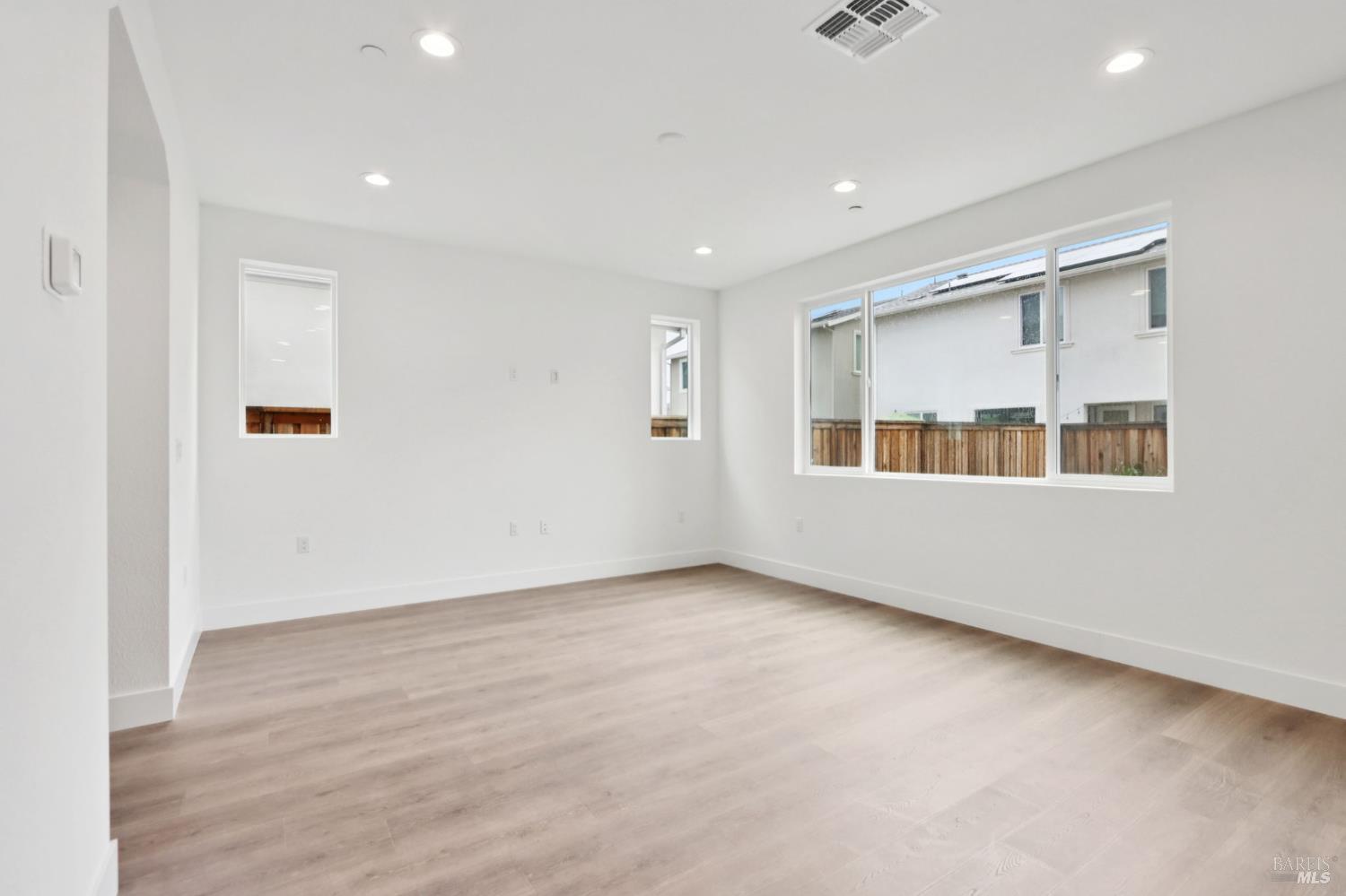 1556 Country Manor Drive Santa Rosa, CA 95403 - Photo 11 of 40 a view of an empty room with window and wooden floor