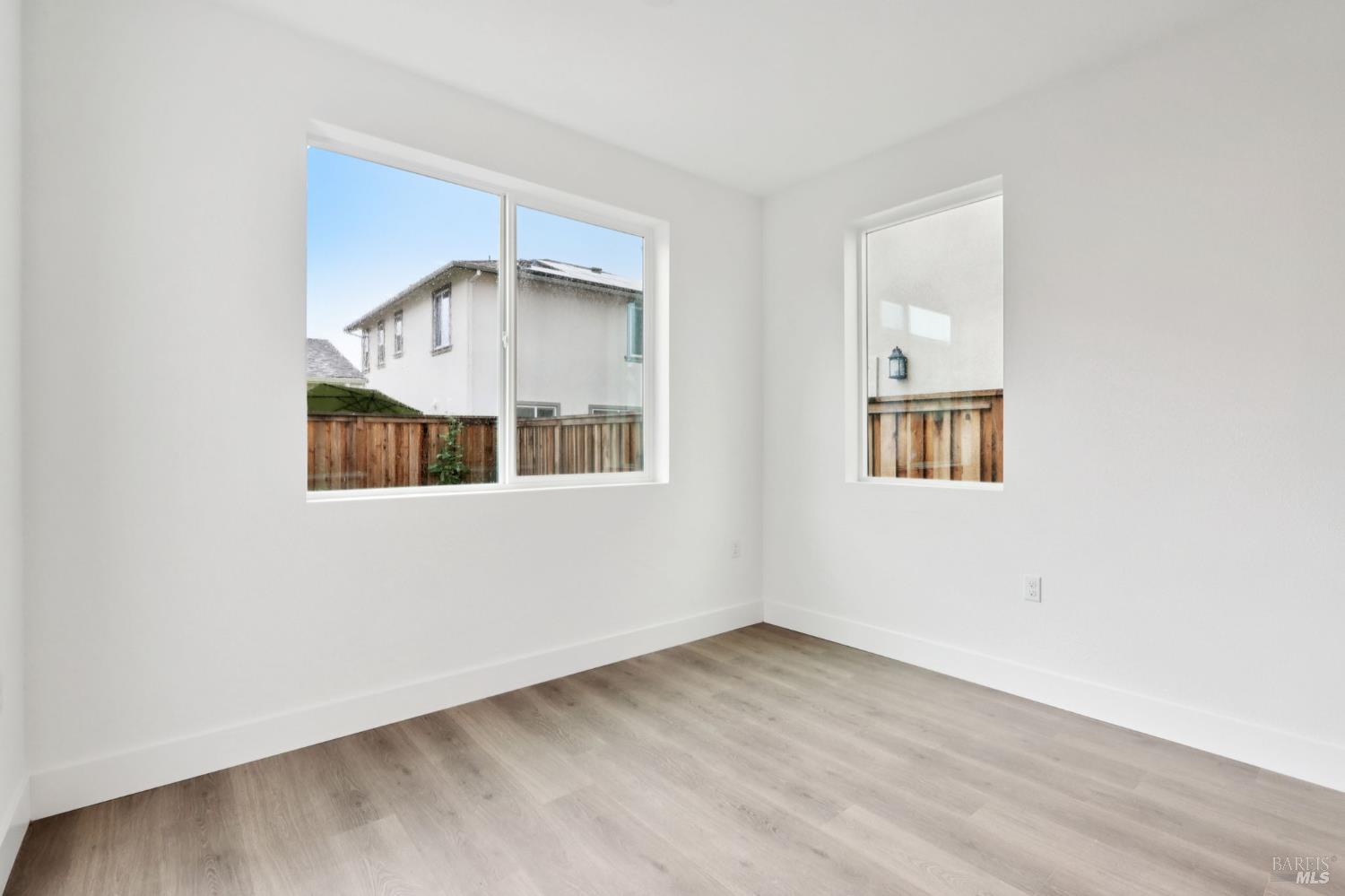 1556 Country Manor Drive Santa Rosa, CA 95403 - Photo 15 of 40 an empty room with wooden floor and windows
