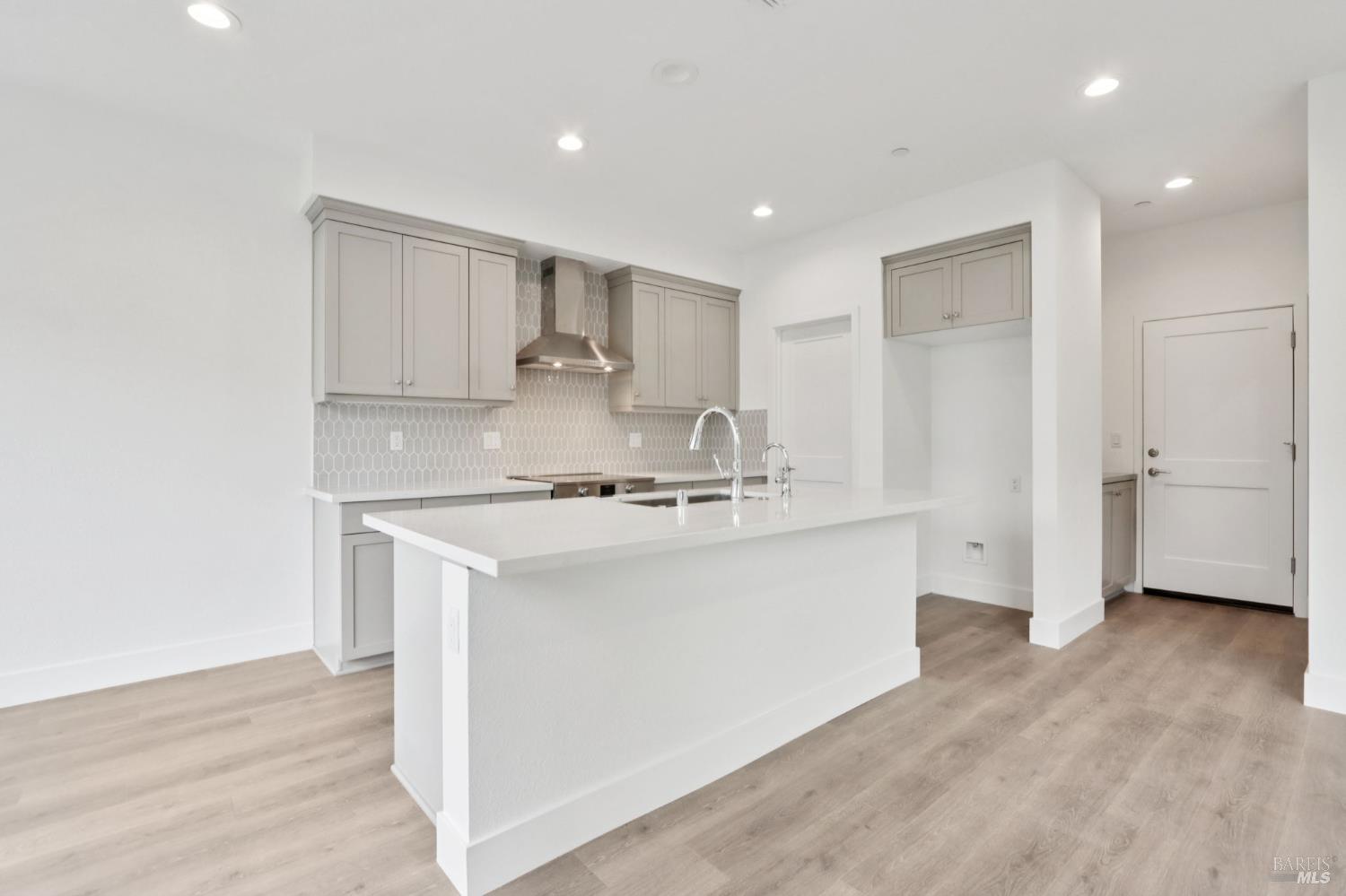 1556 Country Manor Drive Santa Rosa, CA 95403 - Photo 20 of 40 a kitchen with stainless steel appliances cabinets a sink and a wooden floor