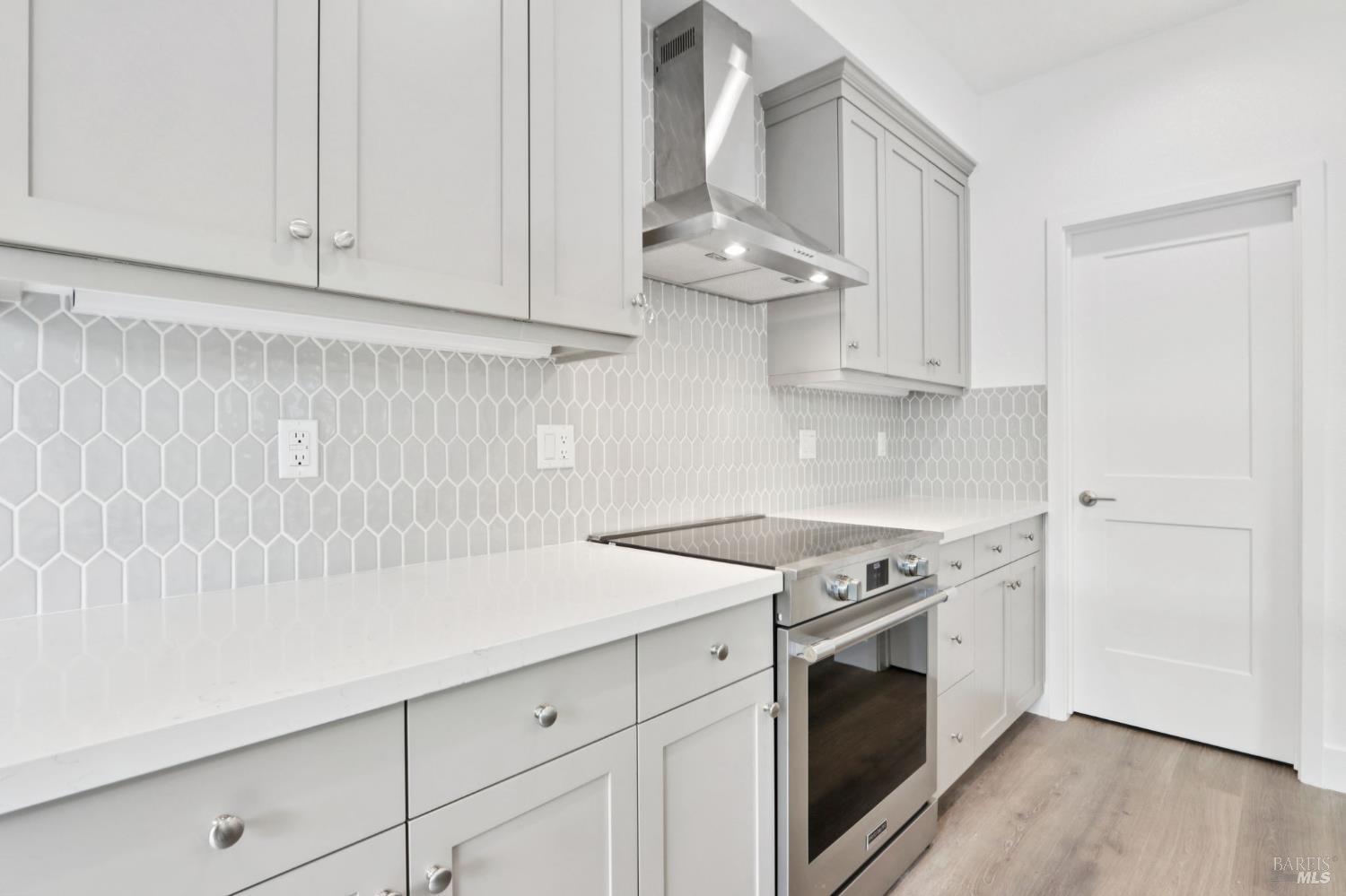 1556 Country Manor Drive Santa Rosa, CA 95403 - Photo 23 of 40 a kitchen with granite countertop white cabinets and a stove