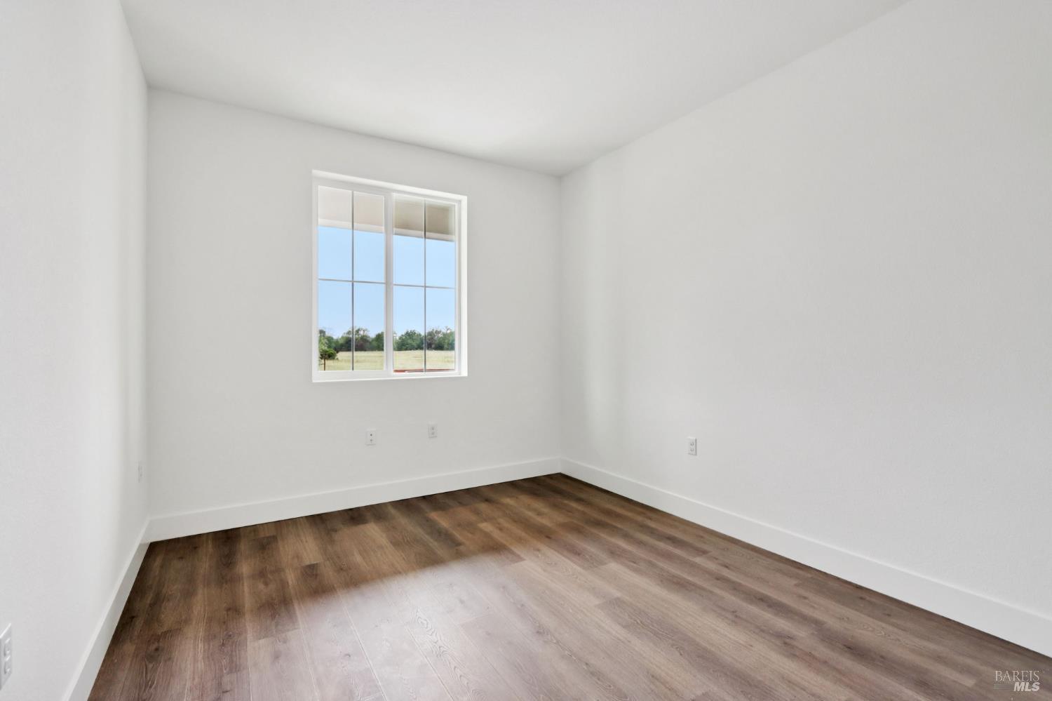 1556 Country Manor Drive Santa Rosa, CA 95403 - Photo 24 of 40 a view of a room that has wooden floor and windows in it