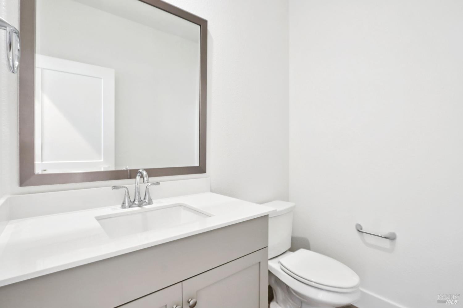 1556 Country Manor Drive Santa Rosa, CA 95403 - Photo 26 of 40 a bathroom with a sink a toilet and mirror