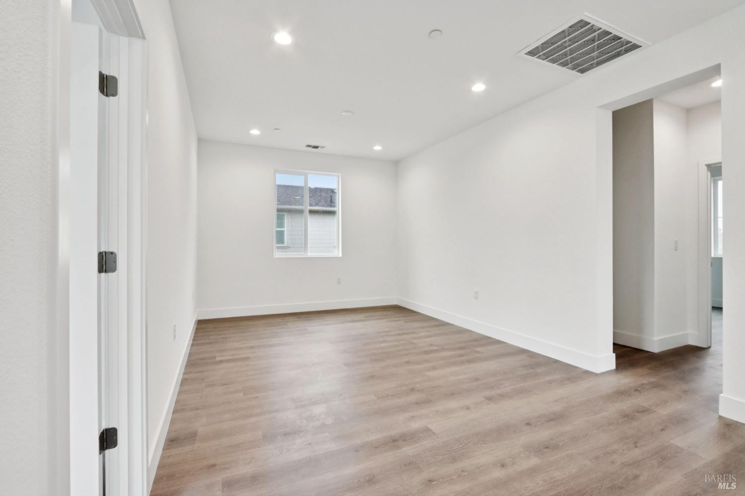 1556 Country Manor Drive Santa Rosa, CA 95403 - Photo 27 of 40 an empty room with wooden floor and windows