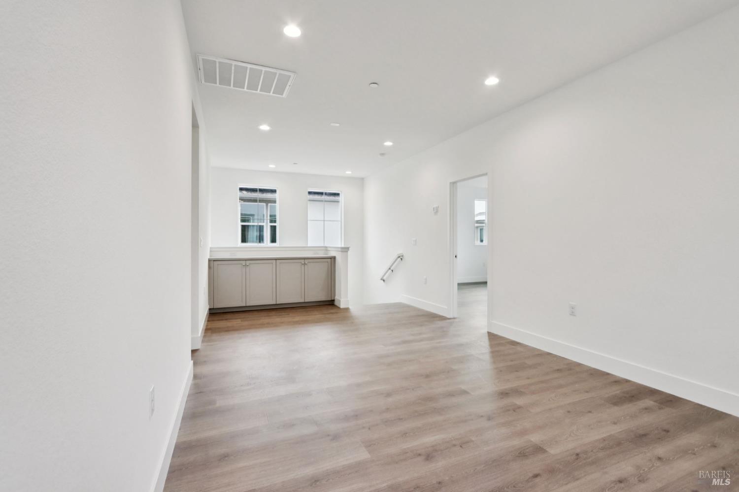1556 Country Manor Drive Santa Rosa, CA 95403 - Photo 28 of 40 a view of an empty room with wooden floor and a window