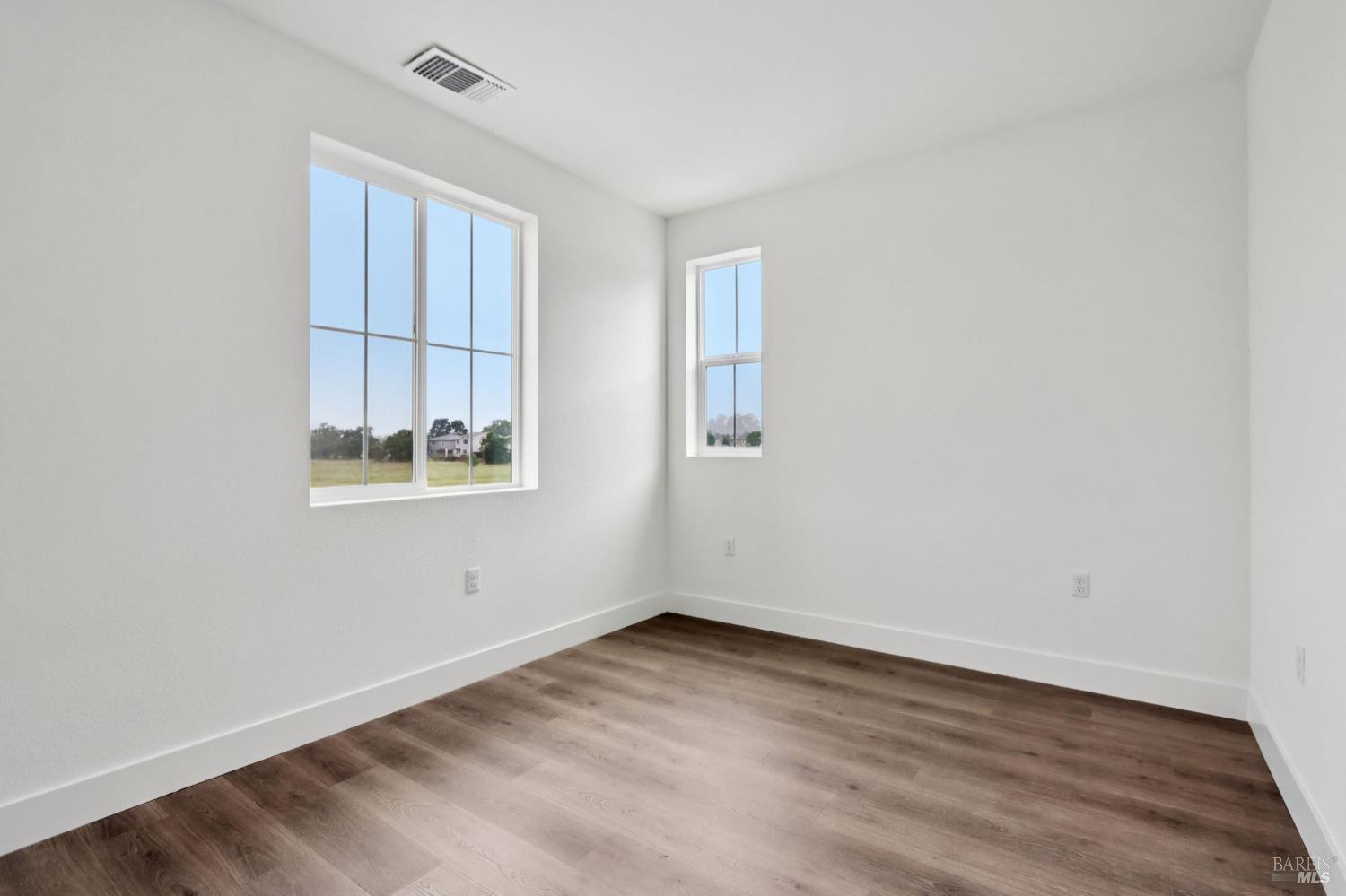 1556 Country Manor Drive Santa Rosa, CA 95403 - Photo 29 of 40 an empty room with wooden floor and windows