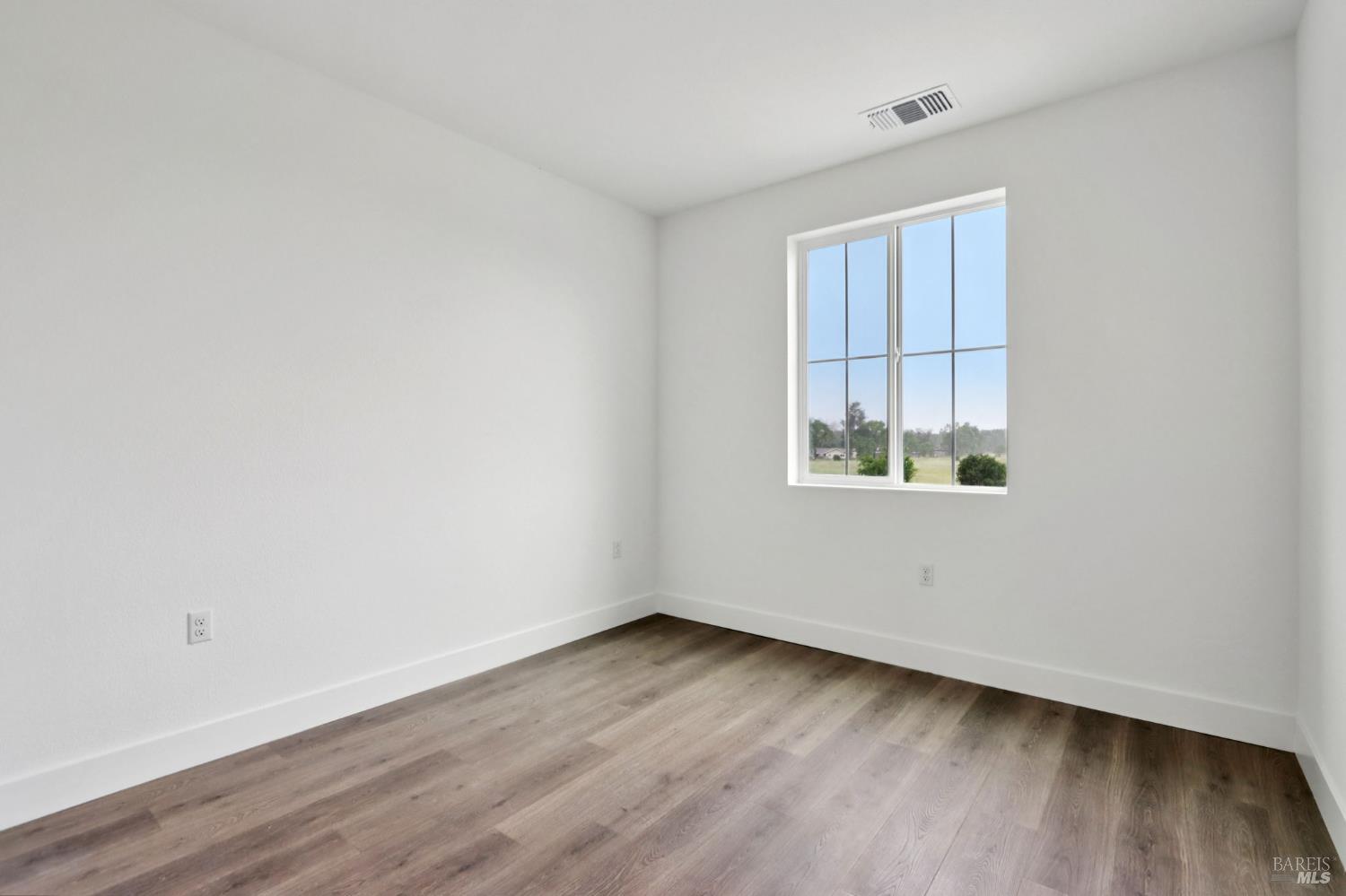1556 Country Manor Drive Santa Rosa, CA 95403 - Photo 31 of 40 an empty room with wooden floor and windows