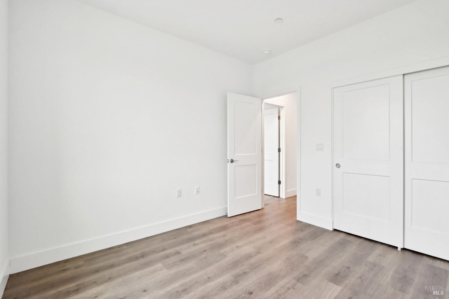 1556 Country Manor Drive Santa Rosa, CA 95403 - Photo 32 of 40 an empty room with wooden floor