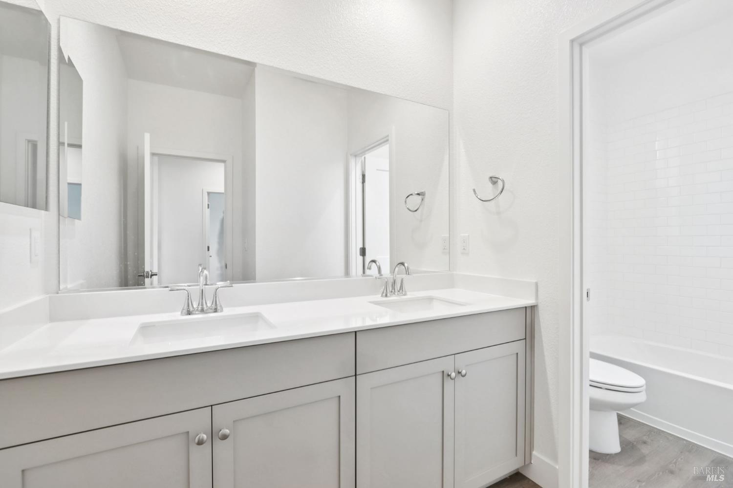 1556 Country Manor Drive Santa Rosa, CA 95403 - Photo 33 of 40 a bathroom with a granite countertop sink a toilet and a mirror