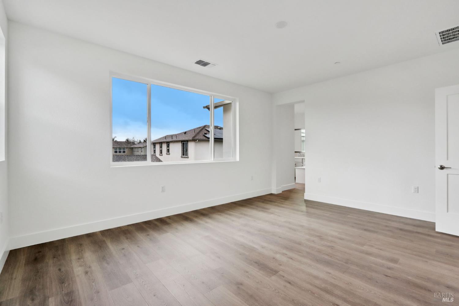 1556 Country Manor Drive Santa Rosa, CA 95403 - Photo 36 of 40 a view of an empty room with wooden floor and a window