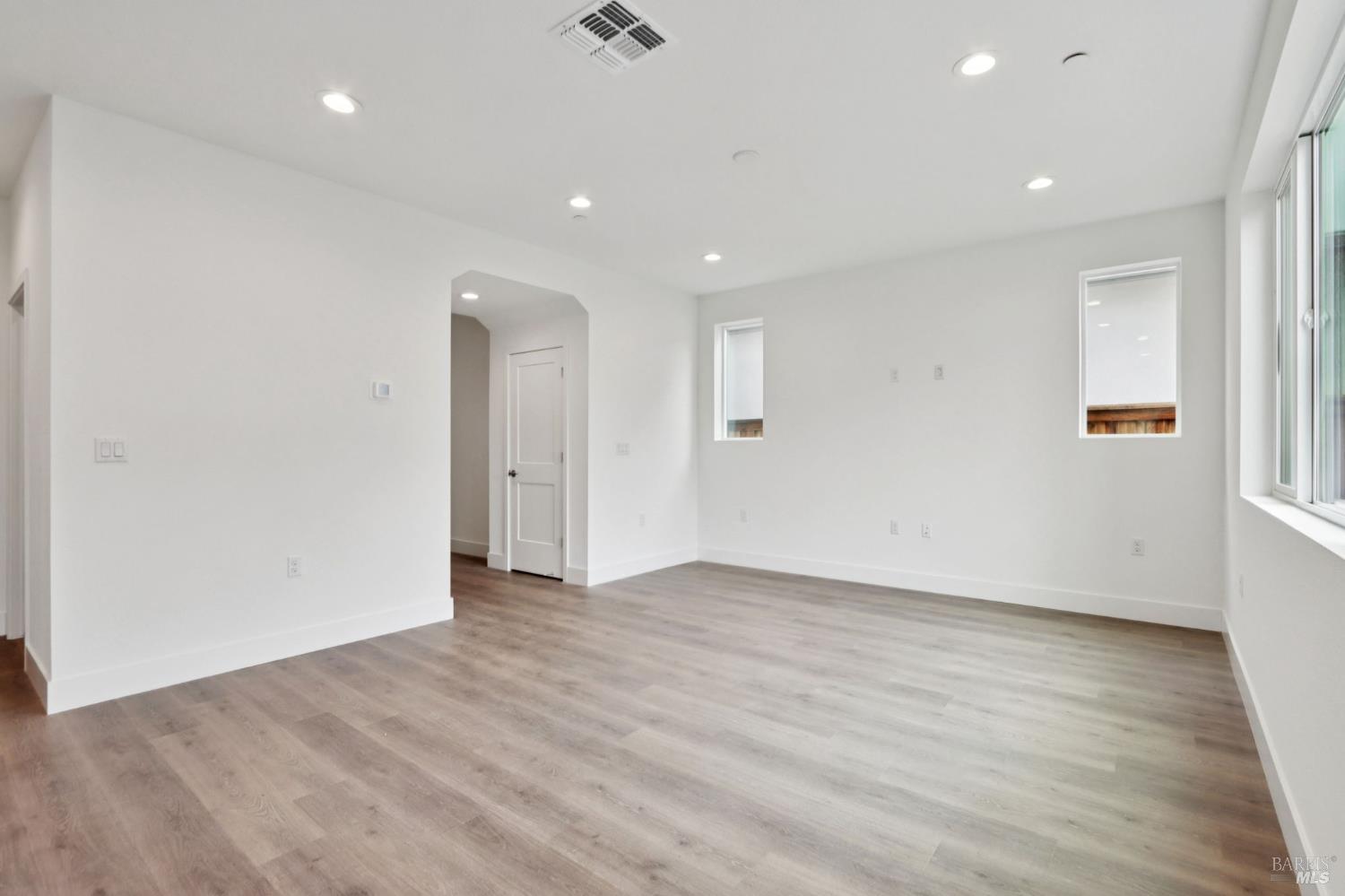 1556 Country Manor Drive Santa Rosa, CA 95403 - Photo 9 of 40 an empty room with wooden floor and windows