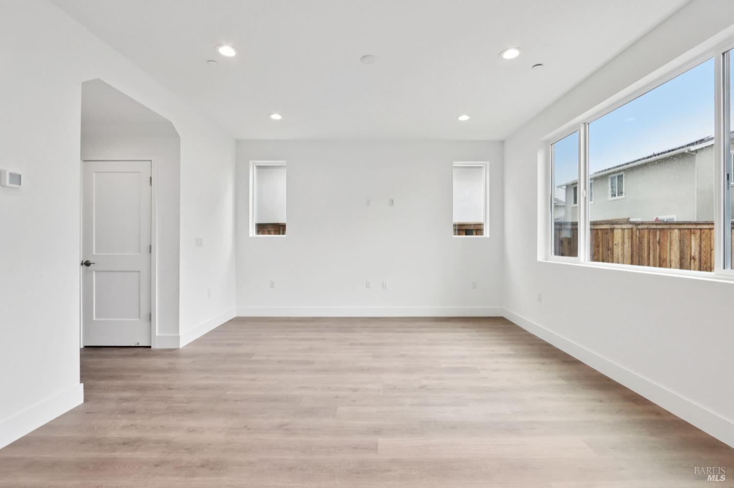 1556 Country Manor Drive Santa Rosa, CA 95403 - Photo 10 of 40 a view of an empty room with wooden floor and windows