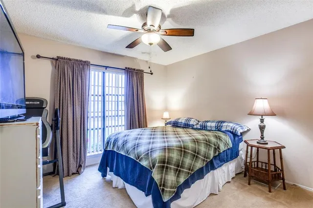 a bedroom with a bed chandelier and a window