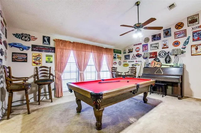 a room with furniture and pool table