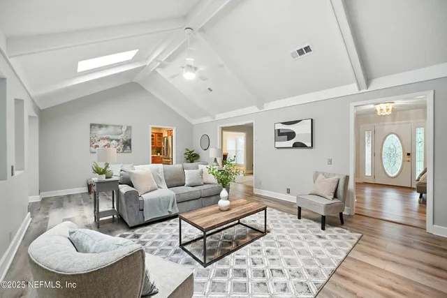 a living room with furniture fireplace and wooden floor