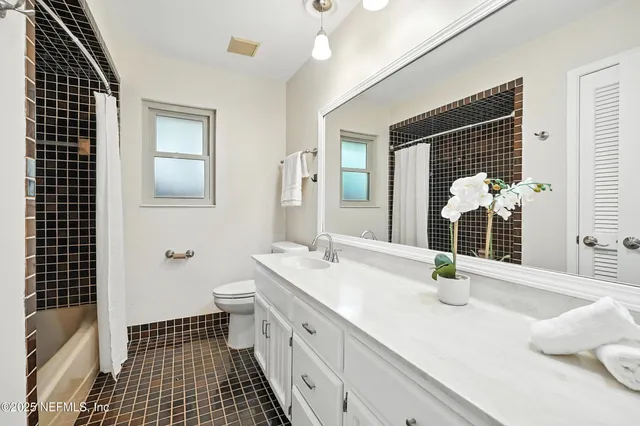 a view of a backyard with a small deck and wooden floor