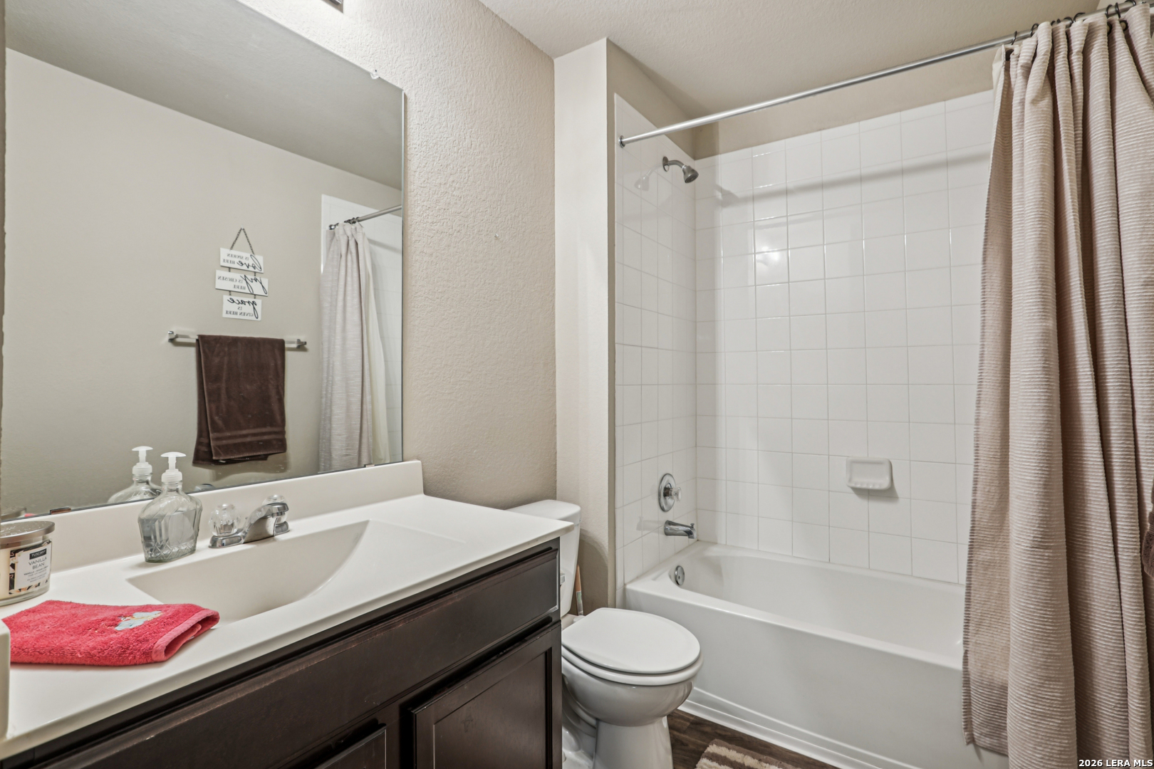 12103 Riprap Drive Manor, TX 78653 - Photo 12 of 13 a bathroom with a granite countertop sink toilet and shower