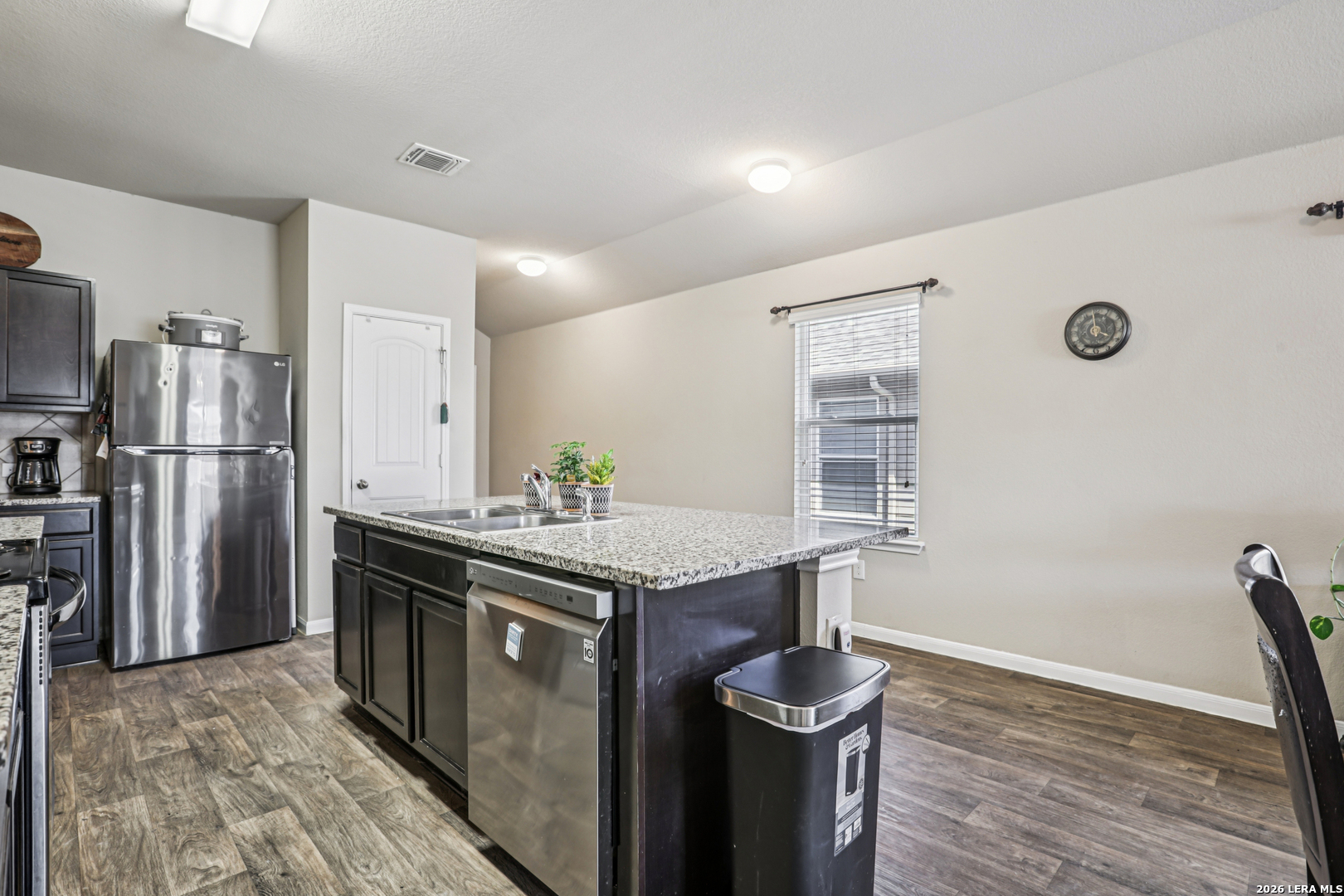 12103 Riprap Drive Manor, TX 78653 - Photo 9 of 13 a kitchen with stainless steel appliances granite countertop a stove and a refrigerator