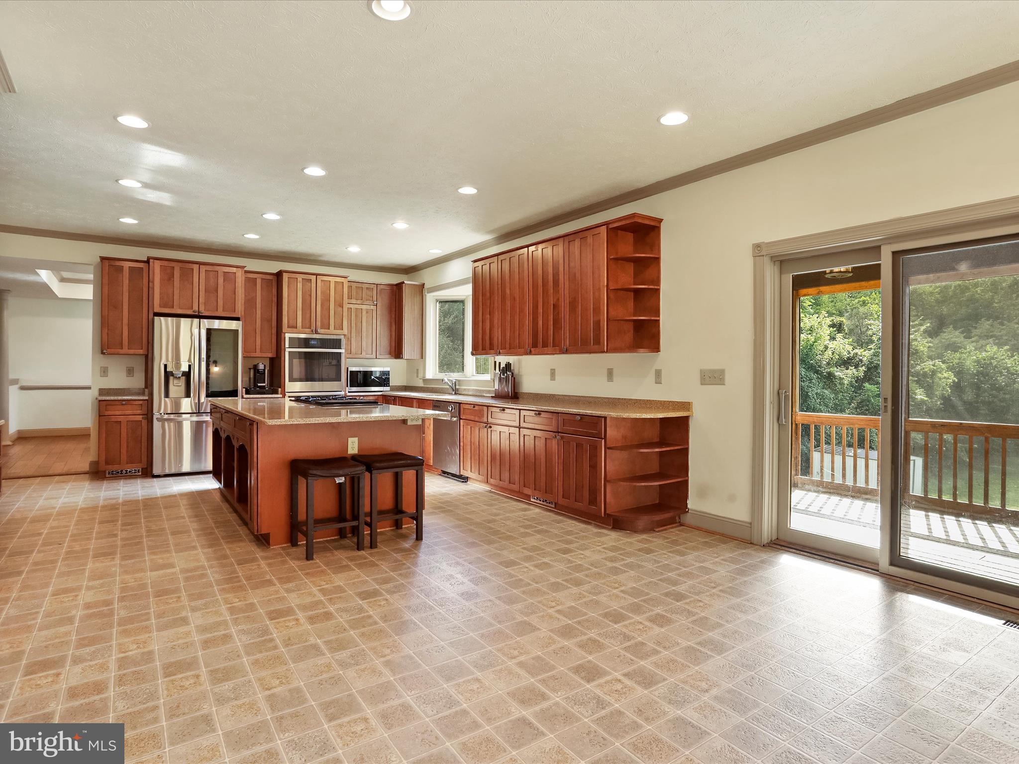 15 Rachels Ln Road Front Royal, VA 22630 - Photo 53 of 73 a kitchen with kitchen island granite countertop wooden cabinets a sink a stove and a stainless steel appliances