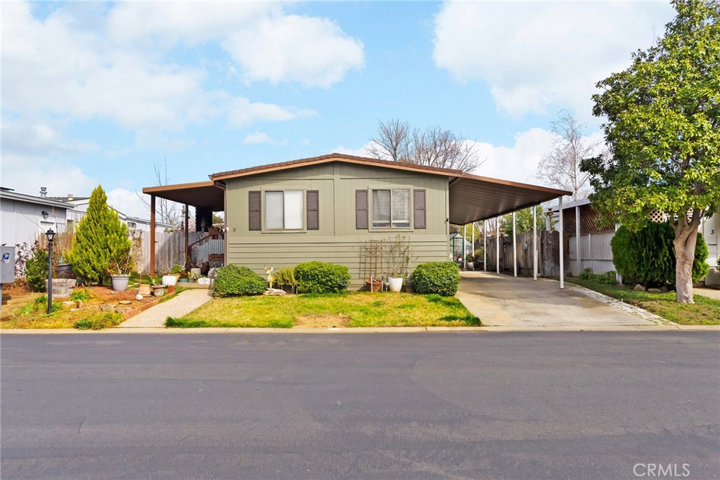 a front view of house with yard and green space