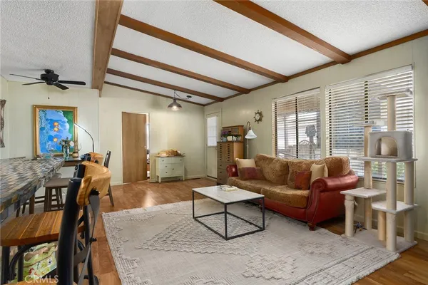 a living room with furniture a wooden floor and a window