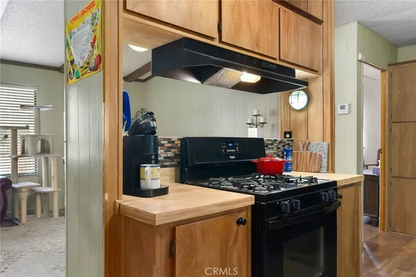 a kitchen with a stove and a cabinets