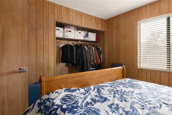 a bedroom with a bed and a window