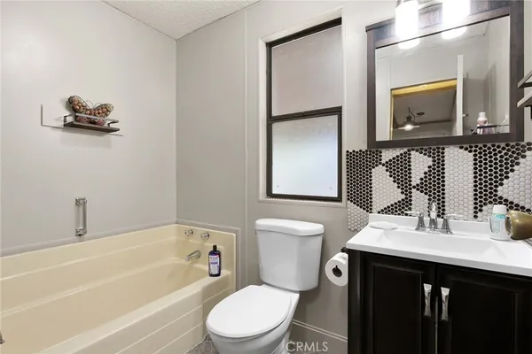 a bathroom with a toilet a sink and a bathtub