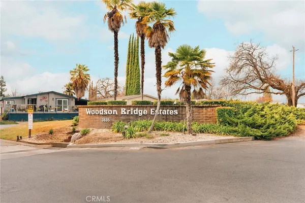 a view of houses with palm trees