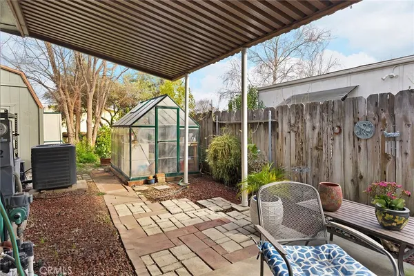 a backyard of a house with barbeque oven table and chairs