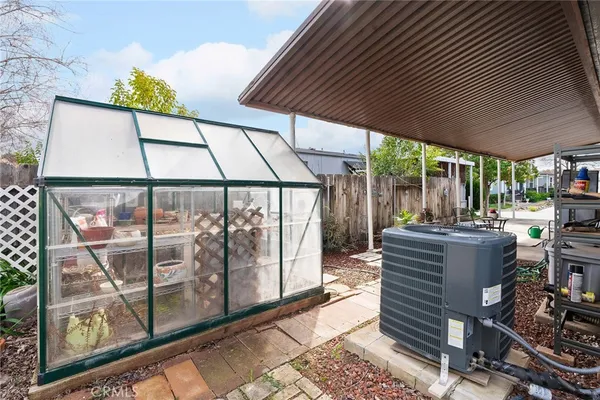 a view of a house with backyard and sitting area