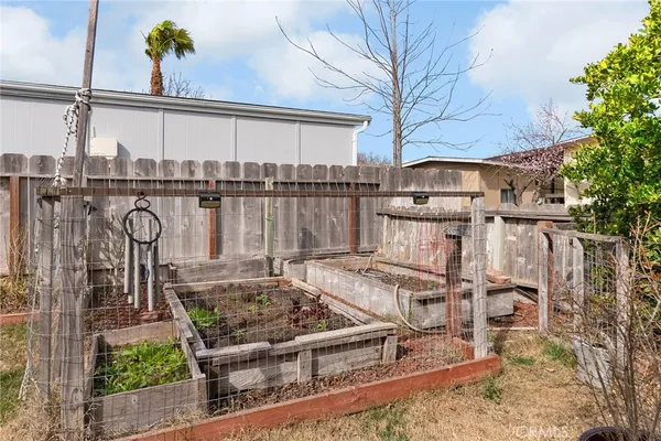 a view of a chairs and table in backyard of the house