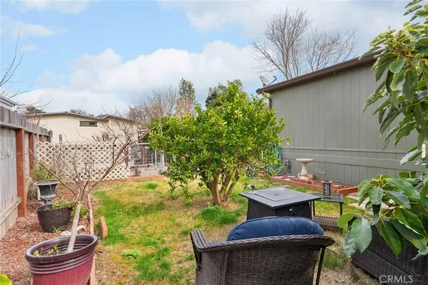 a backyard of a house with table and chairs