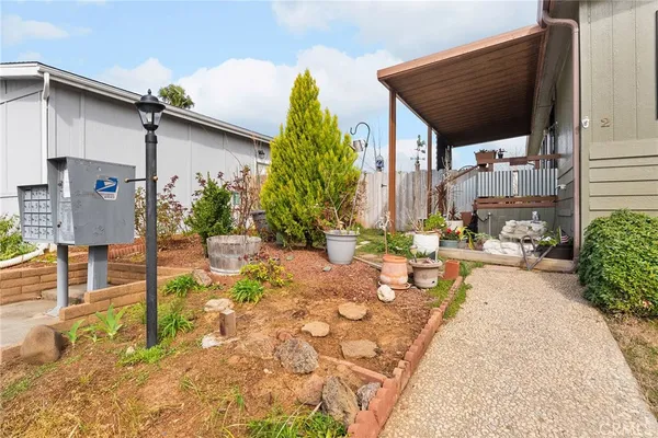 a view of a house with backyard and sitting area