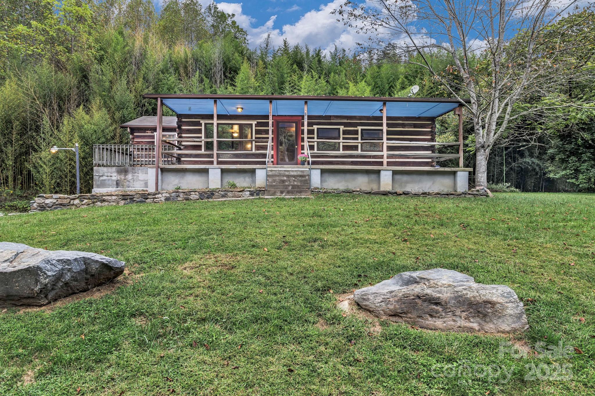 a view of a house with backyard and sitting area