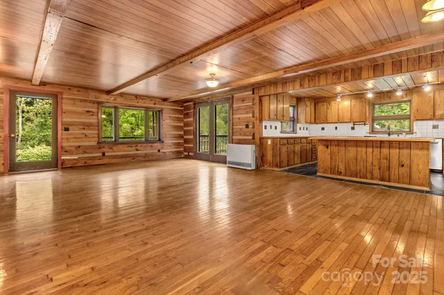 a view of a room with wooden walls and next to a window
