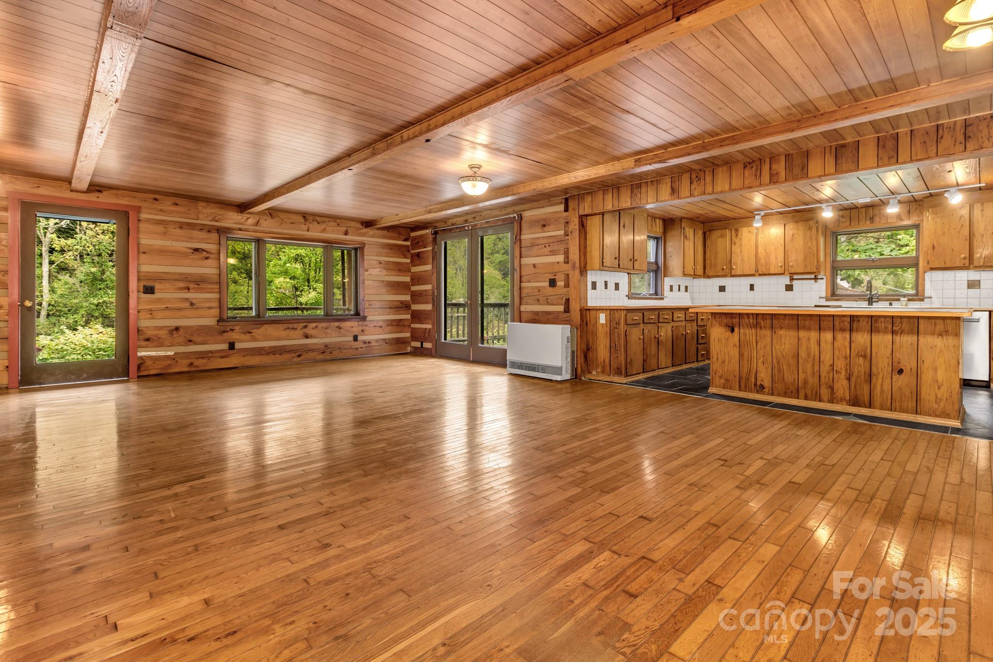 200 Dry Branch Road Marshall, NC 28753 - Photo 12 of 38 a view of a room with lots of wooden furniture and large windows