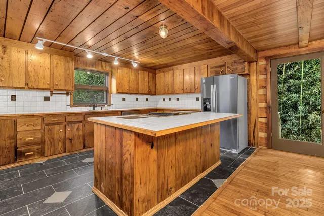 a kitchen with stainless steel appliances a stove sink and cabinets