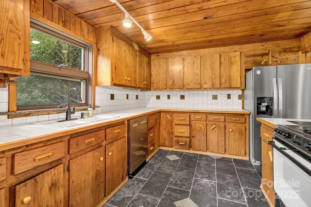 a kitchen that has a stove and a microwave oven