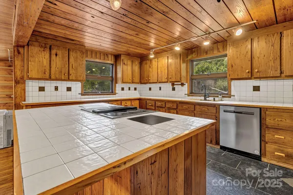 a view of a room with wooden walls and next to a window